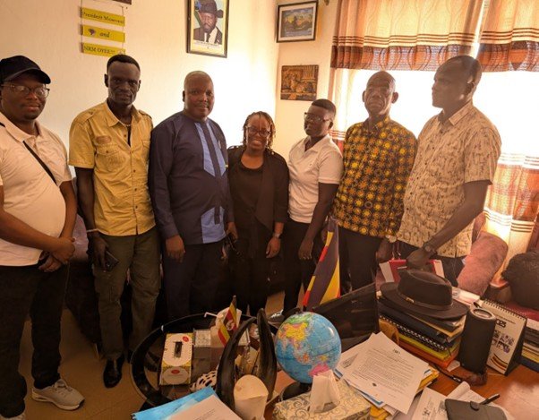 Full length picture of a group of researchers in Uganda smiling